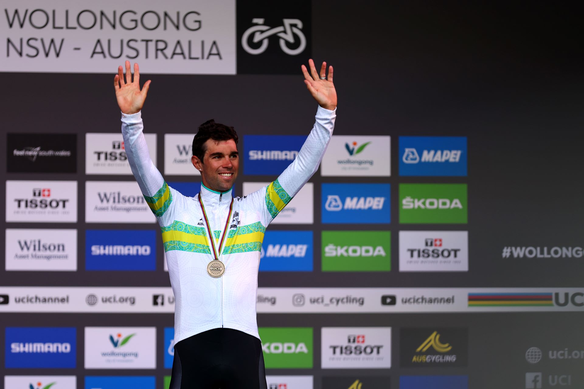 Australian road cyclist Michael Matthews waves from the podium of the 2022 UCI Road World Championships in Wollongong with a silver medal around his neck